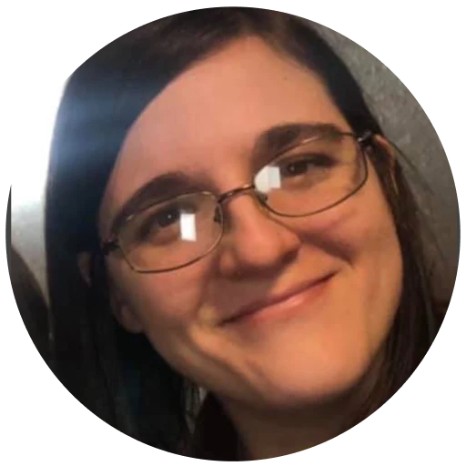 Person with glasses and long dark hair, smiling.