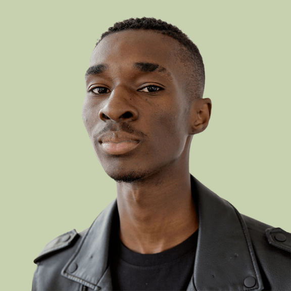 Person wearing a black leather jacket against a light green background.