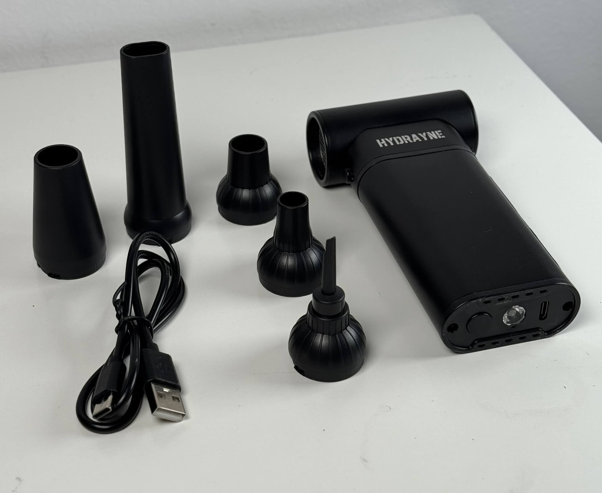 A black portable air compressor featuring a power cord and charger for convenient use.