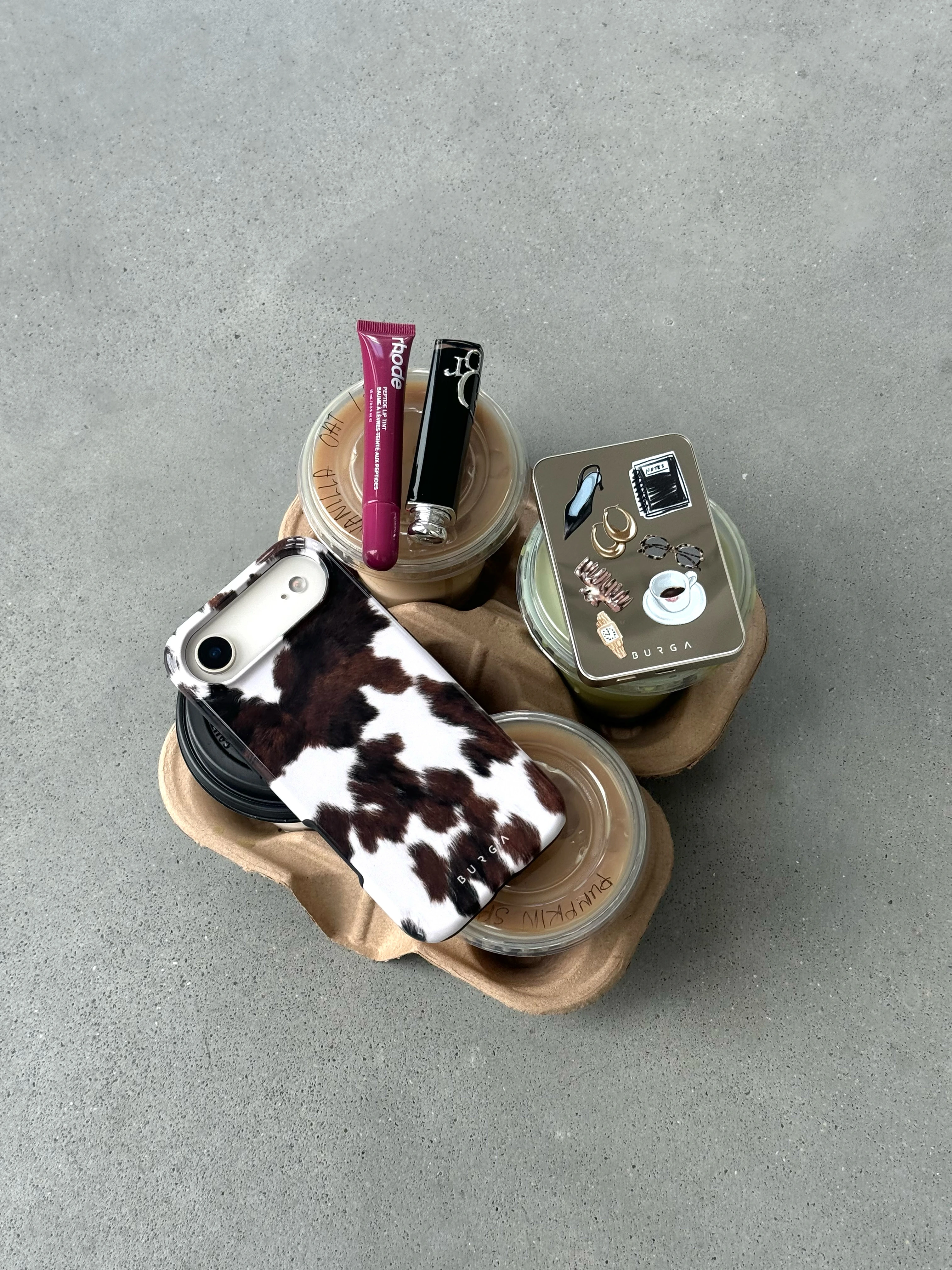 A close-up of the camera lenses on the back of a smartphone in a floral case.