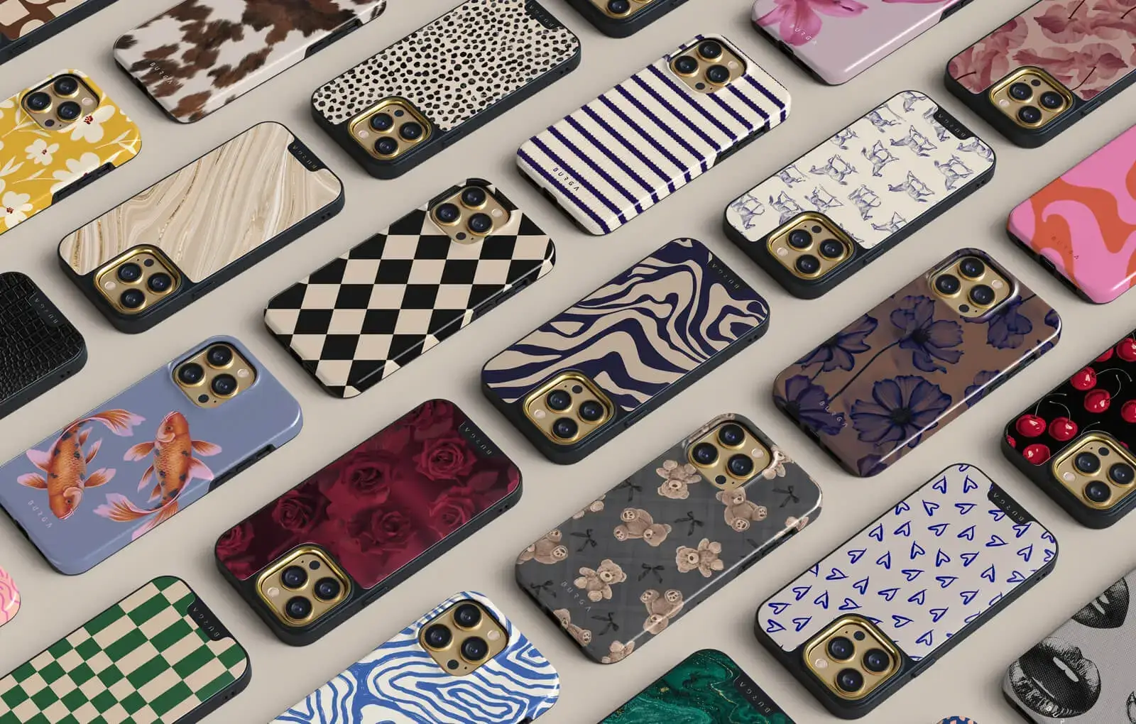Various smartphone cases with diverse patterns and designs displayed on a surface.