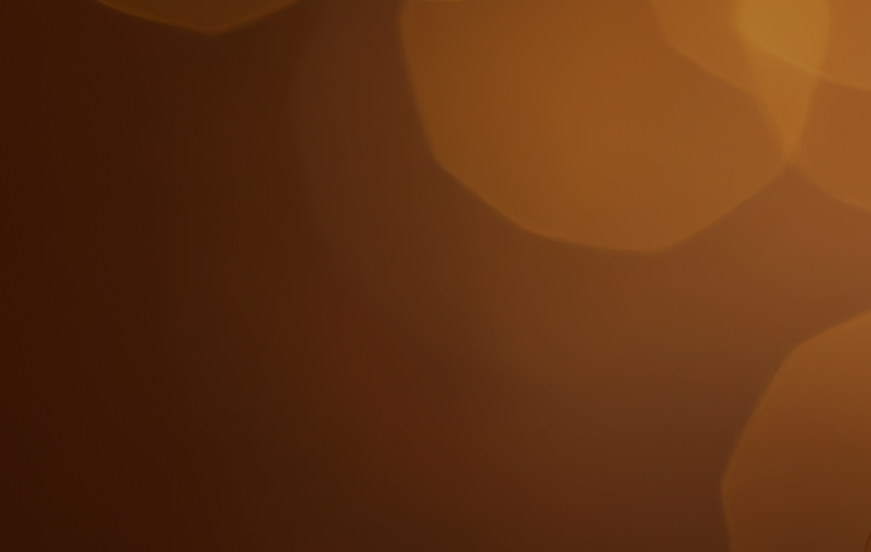 Brown abstract blurry shapes on a dark background.