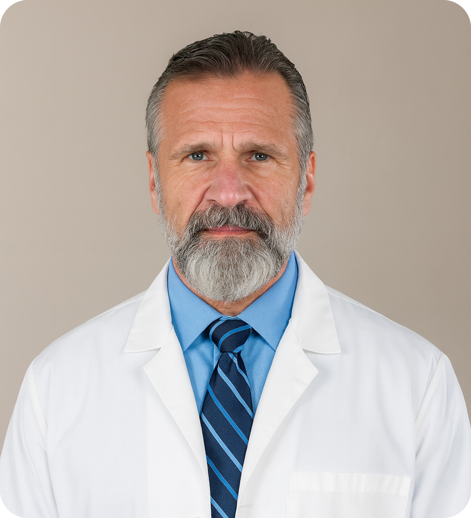 Man with beard in white coat and blue shirt, tie.