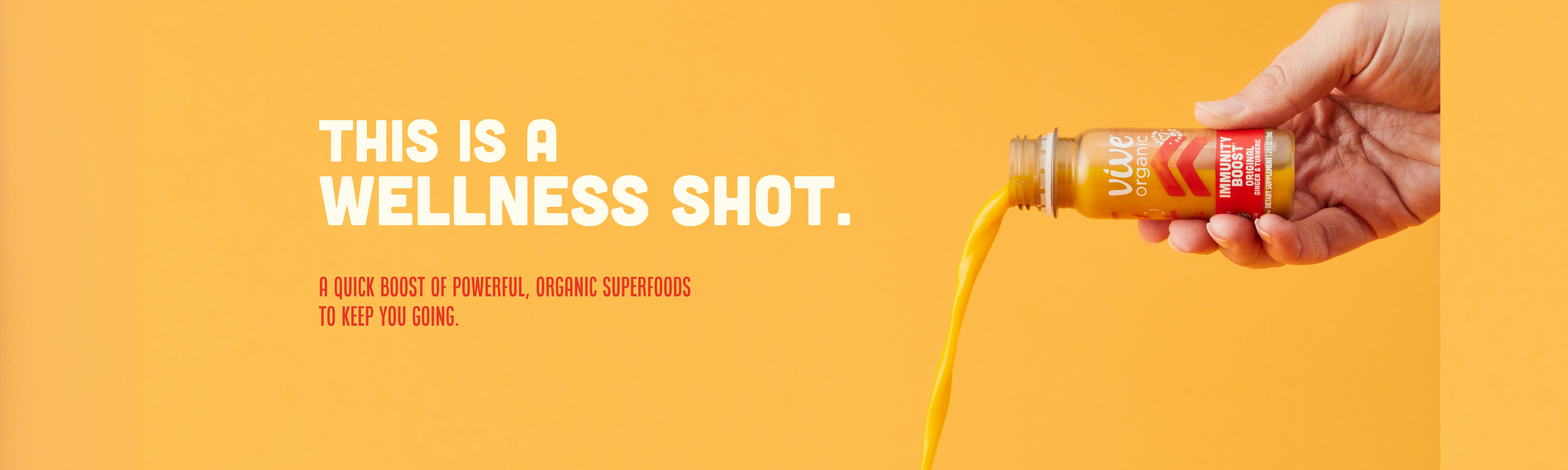 Hand pouring orange wellness shot with text 'This is a wellness shot.'
