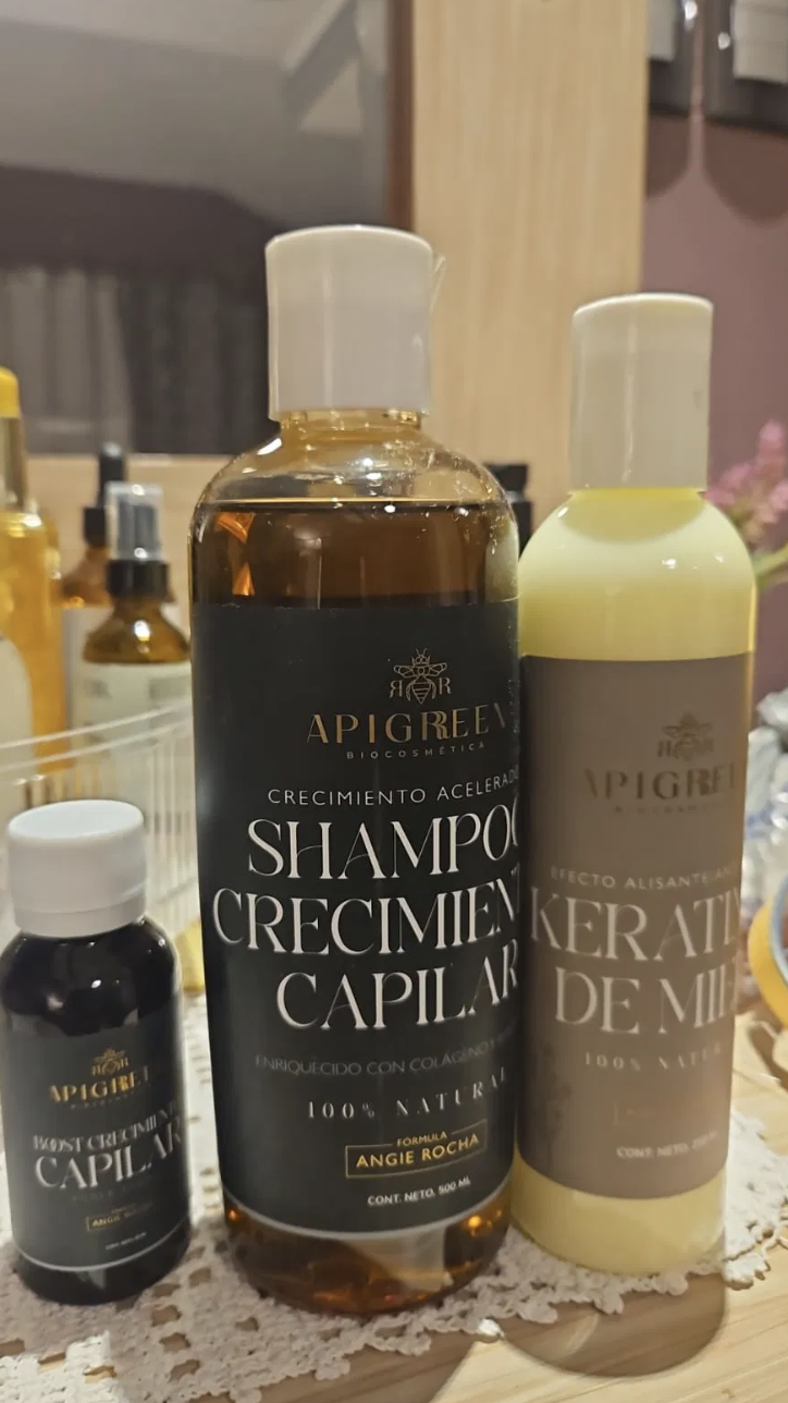 Three hair care products on a wooden table.