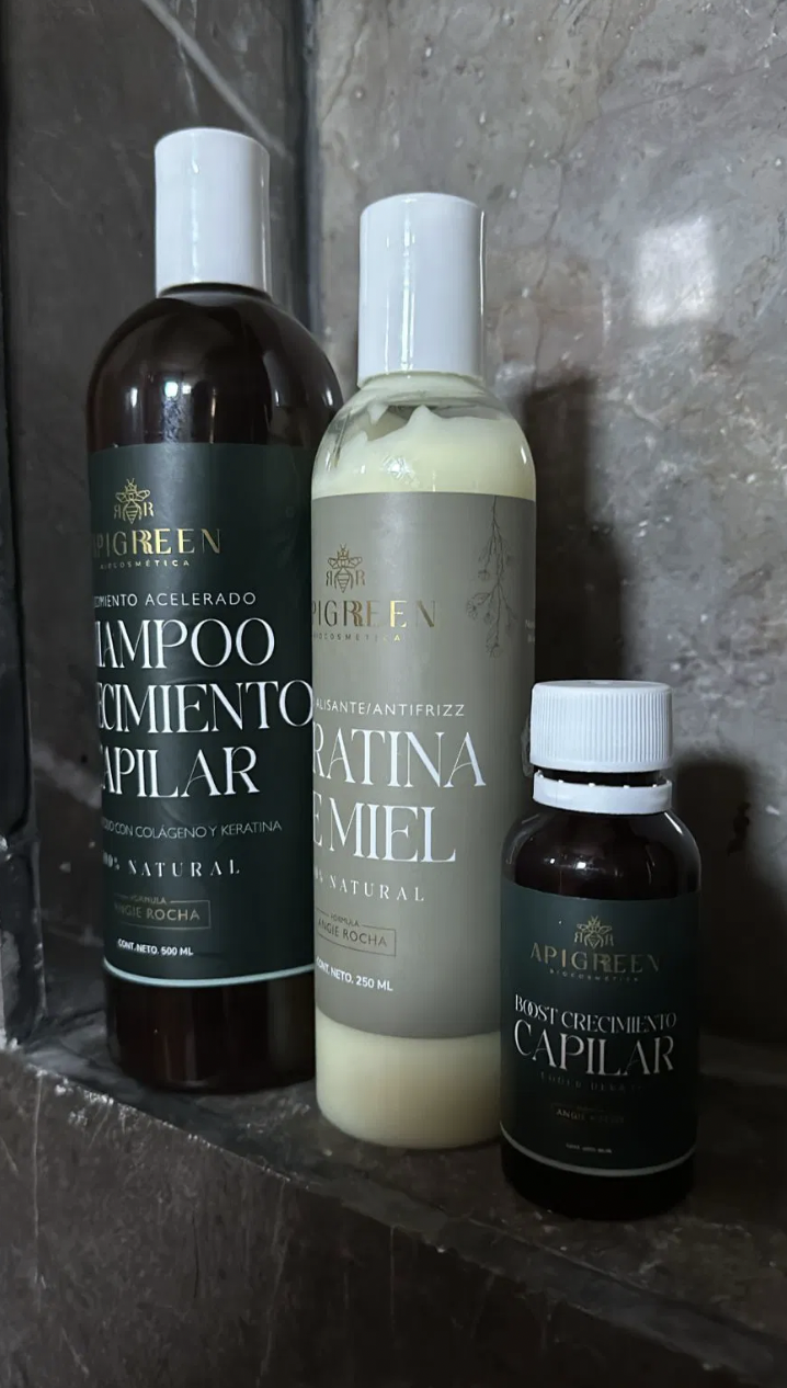 Three Apigreen hair care products on a marble surface.