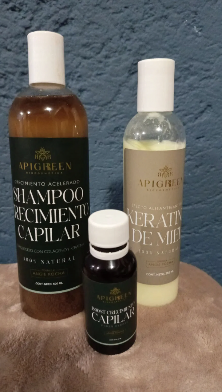 Three bottles of Apigreen hair care products on a textured surface.