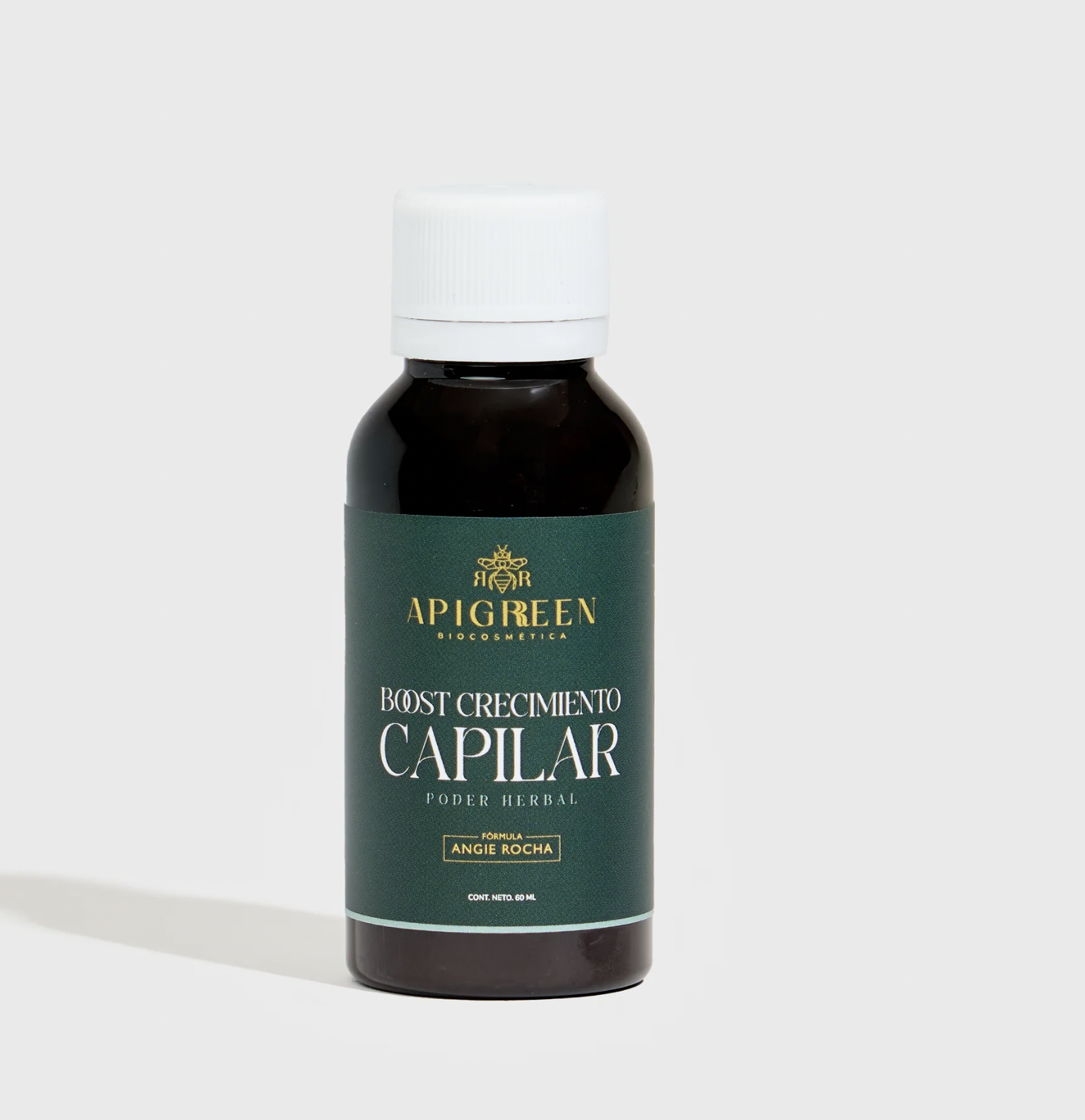 Dark bottle with white cap labeled 'Apigreen Boost Crecimiento Capilar' on a light background.