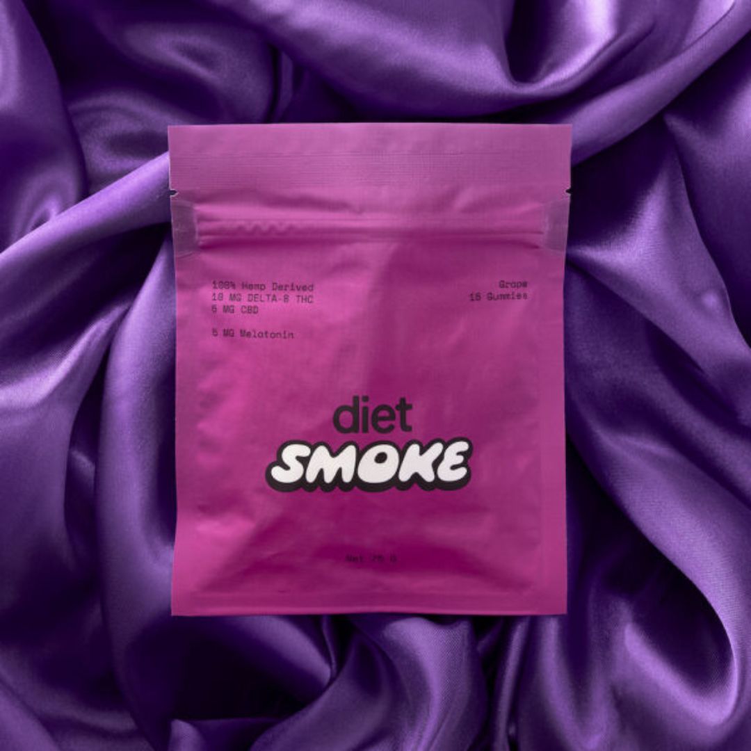 Pink package labeled 'diet SMOKE' on purple satin fabric.