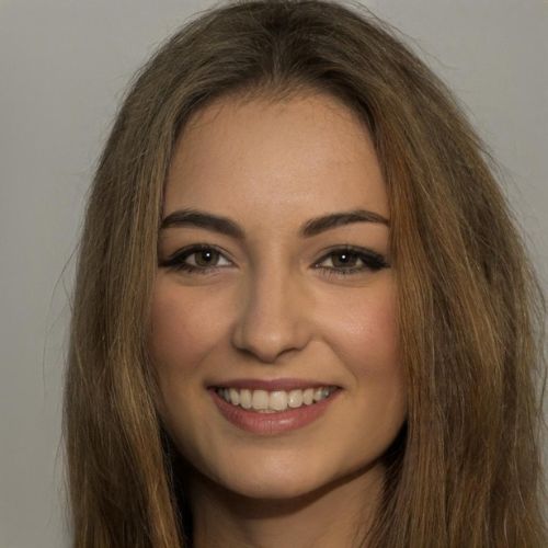 Smiling woman with long brown hair against a plain background.