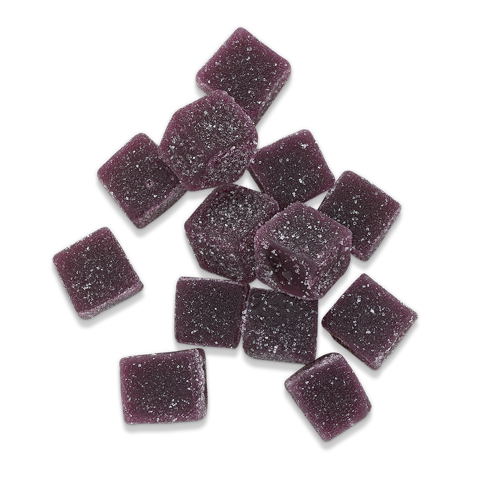 Purple sugar-coated gummy squares on a black background.