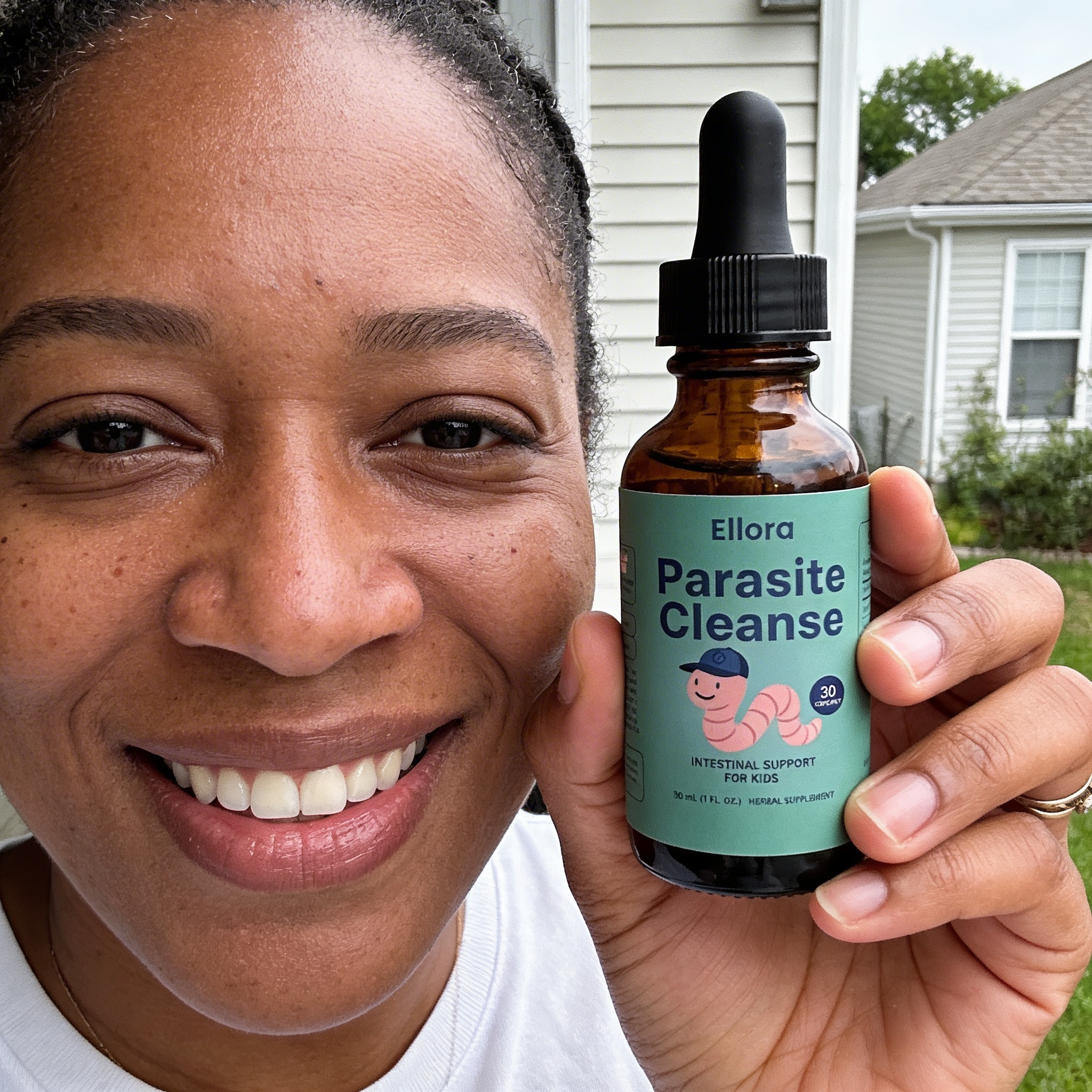 A smiling woman holds a bottle of Ellora Parasite Cleanse intestinal support for kids.