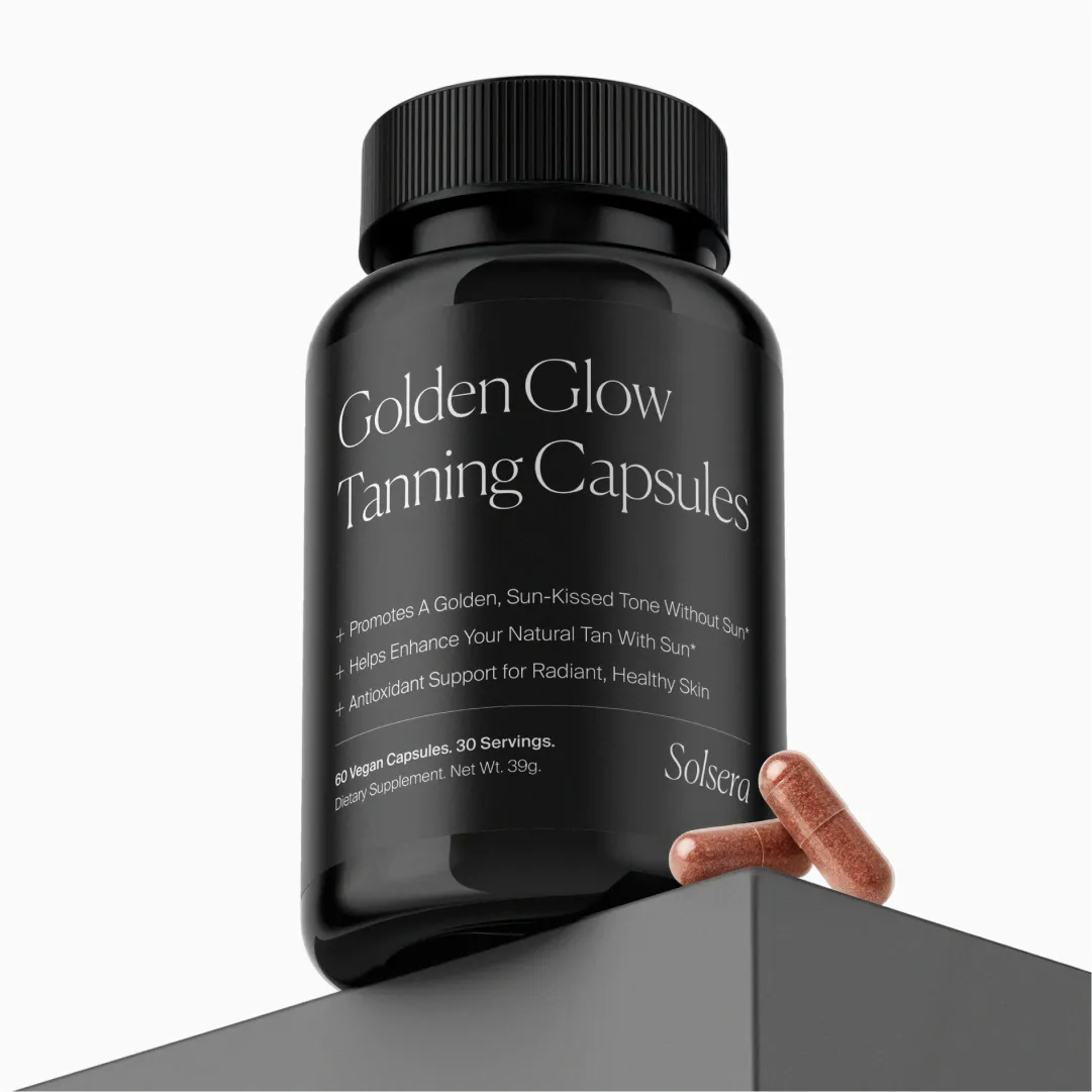 Black bottle labeled 'Golden Glow Tanning Capsules' with two capsules beside it.