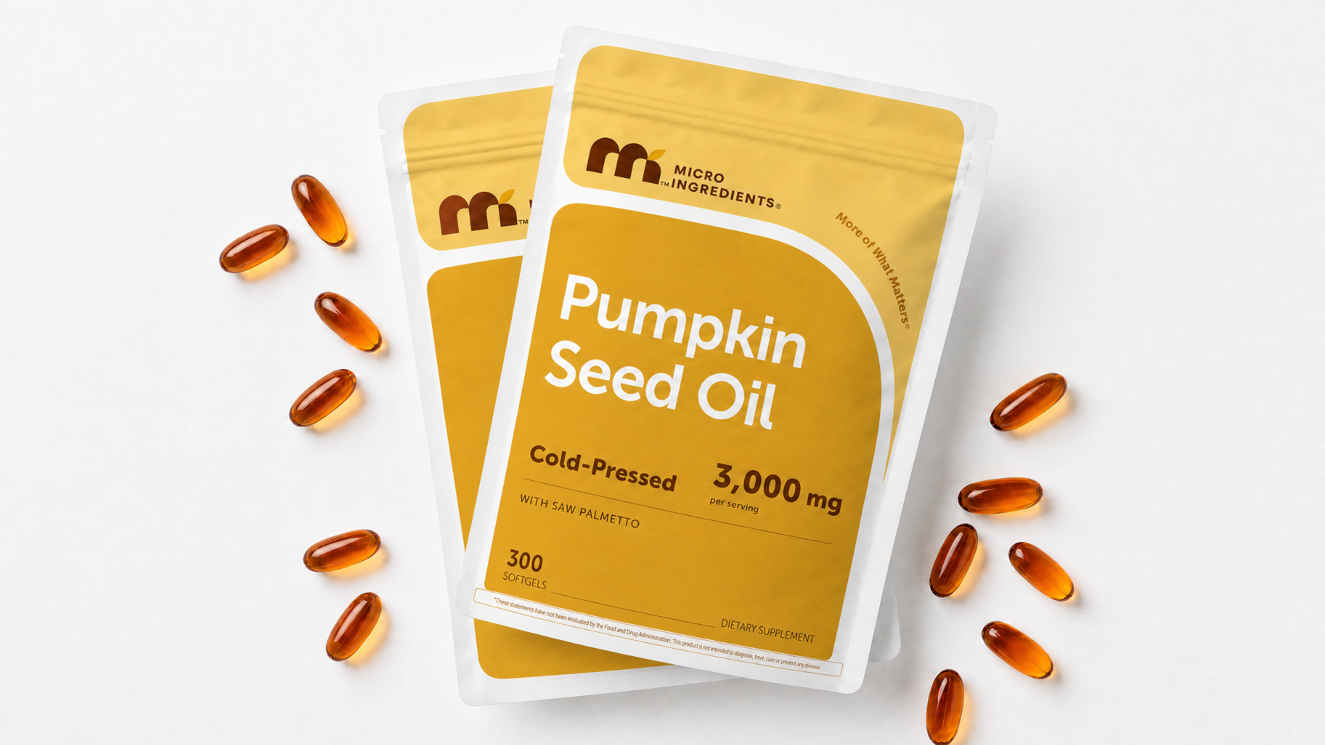 Two pouches of Micro Ingredients Pumpkin Seed Oil with softgels scattered on a white surface.