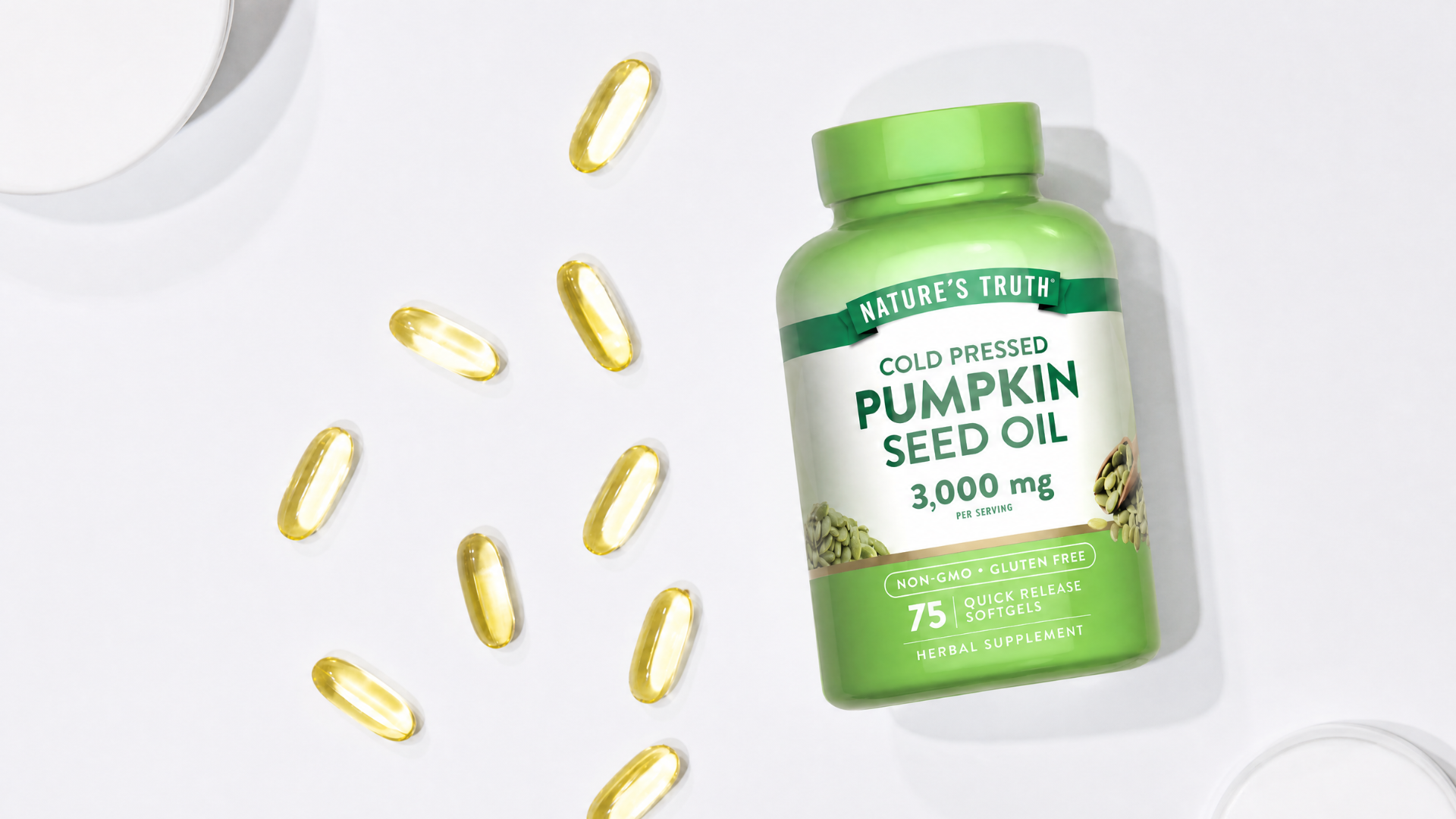 A bottle of Nature's Truth Pumpkin Seed Oil next to several softgels on a white surface.