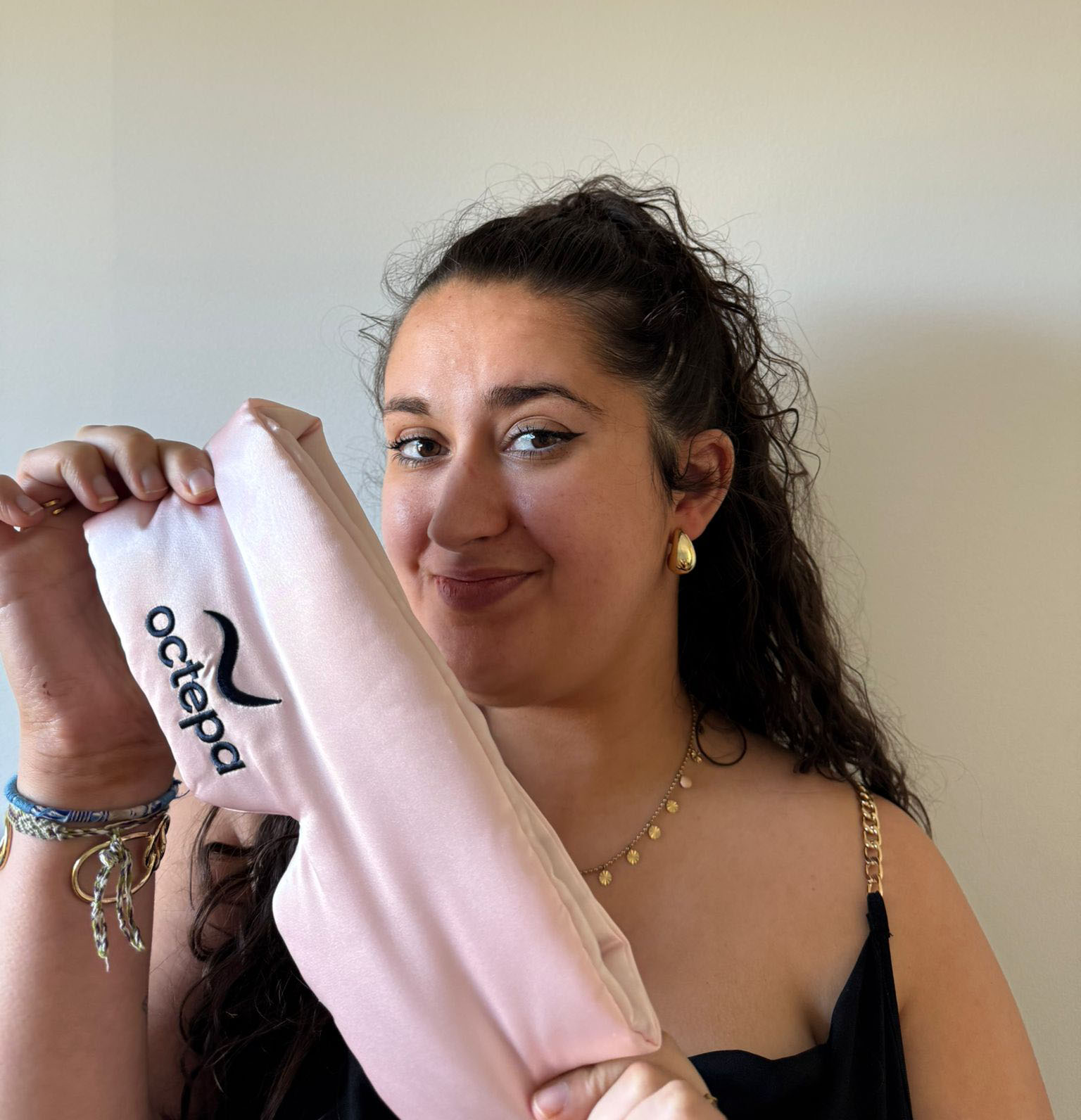 Person holding a pink fabric item with 'octepa' logo.