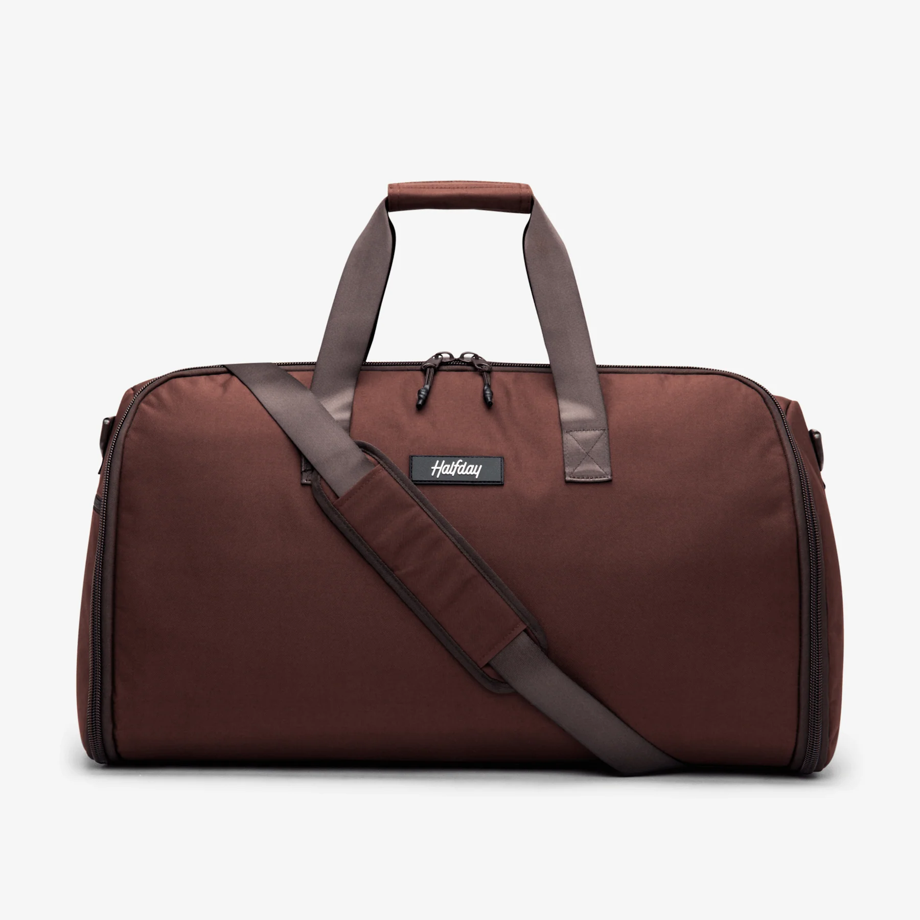 Brown duffel bag with handles and shoulder strap on a white background.