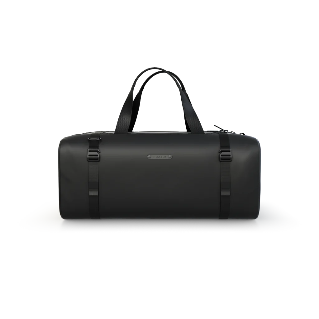 Black duffel bag with handles and buckles on a plain background.
