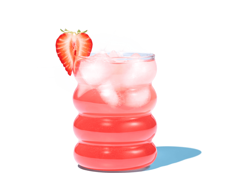 Red beverage with ice and a strawberry garnish in a wavy glass.