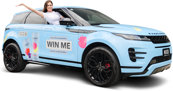 A woman in a car promoting a sweepstakes contest with 'WIN ME' signage.