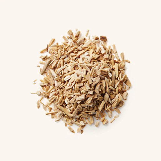 A circular pile of small, light brown wood chips on an off-white background.