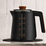A matte black electric kettle with a wooden knob and handle, showing measurement lines on its side.
