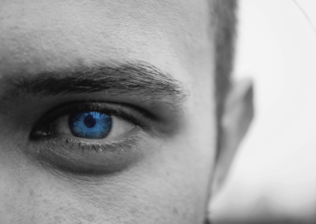Close-up of a person's eye with a bright blue iris.