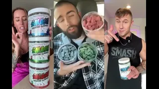 Three people holding and displaying containers of colorful supplements.