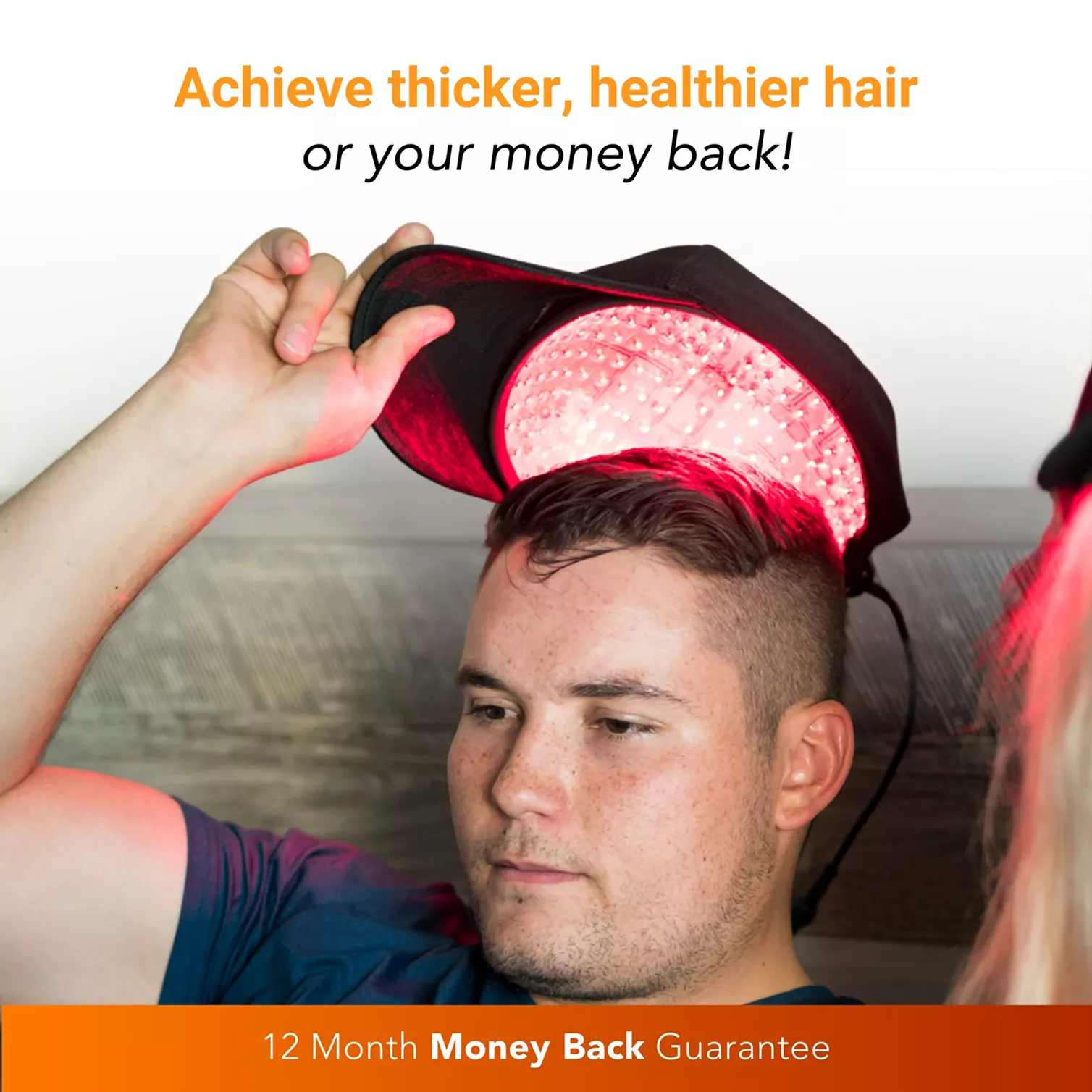 A man places a cap with red LED lights onto his head to stimulate hair growth.