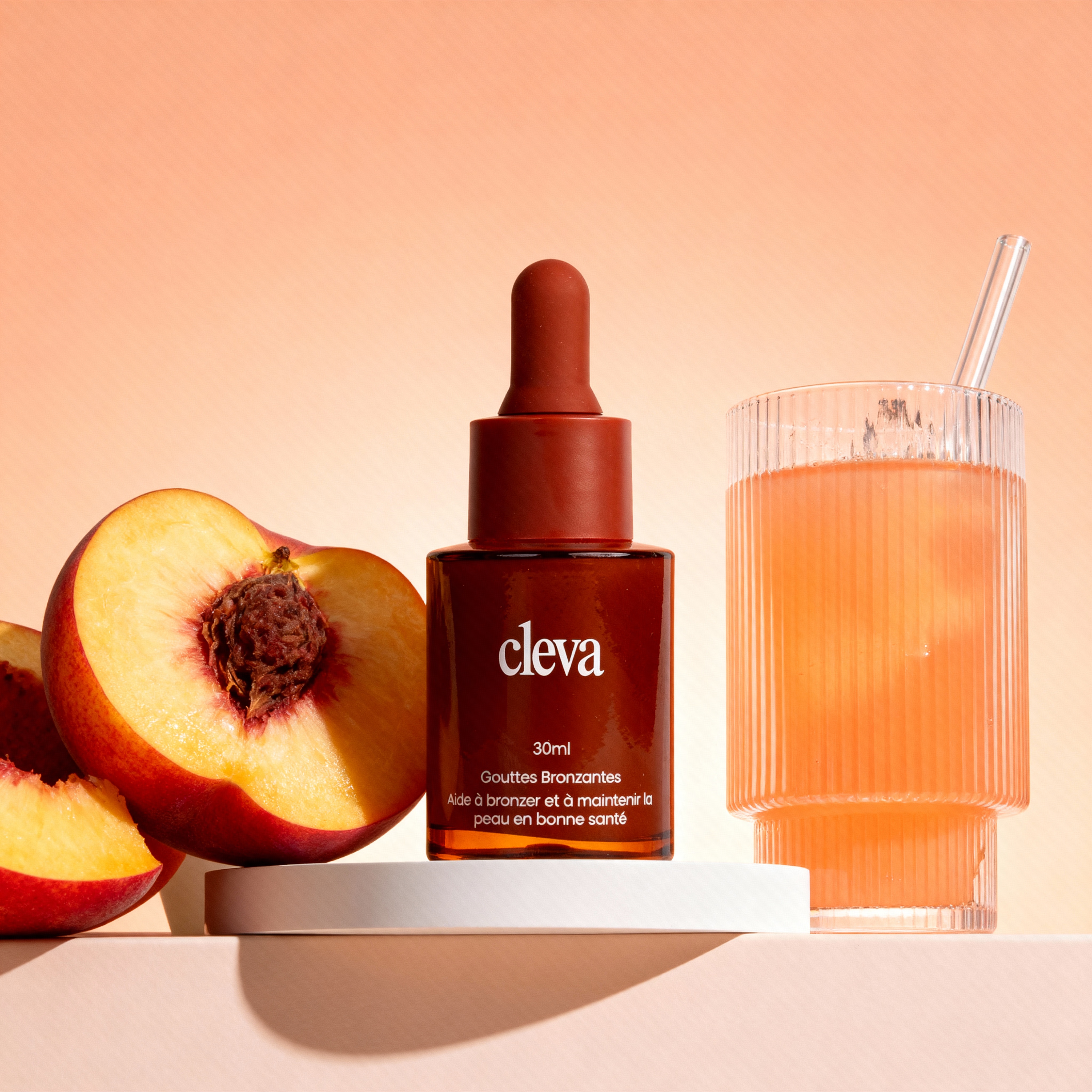Brown dropper bottle, half peach, and glass with orange liquid and straw on light background.