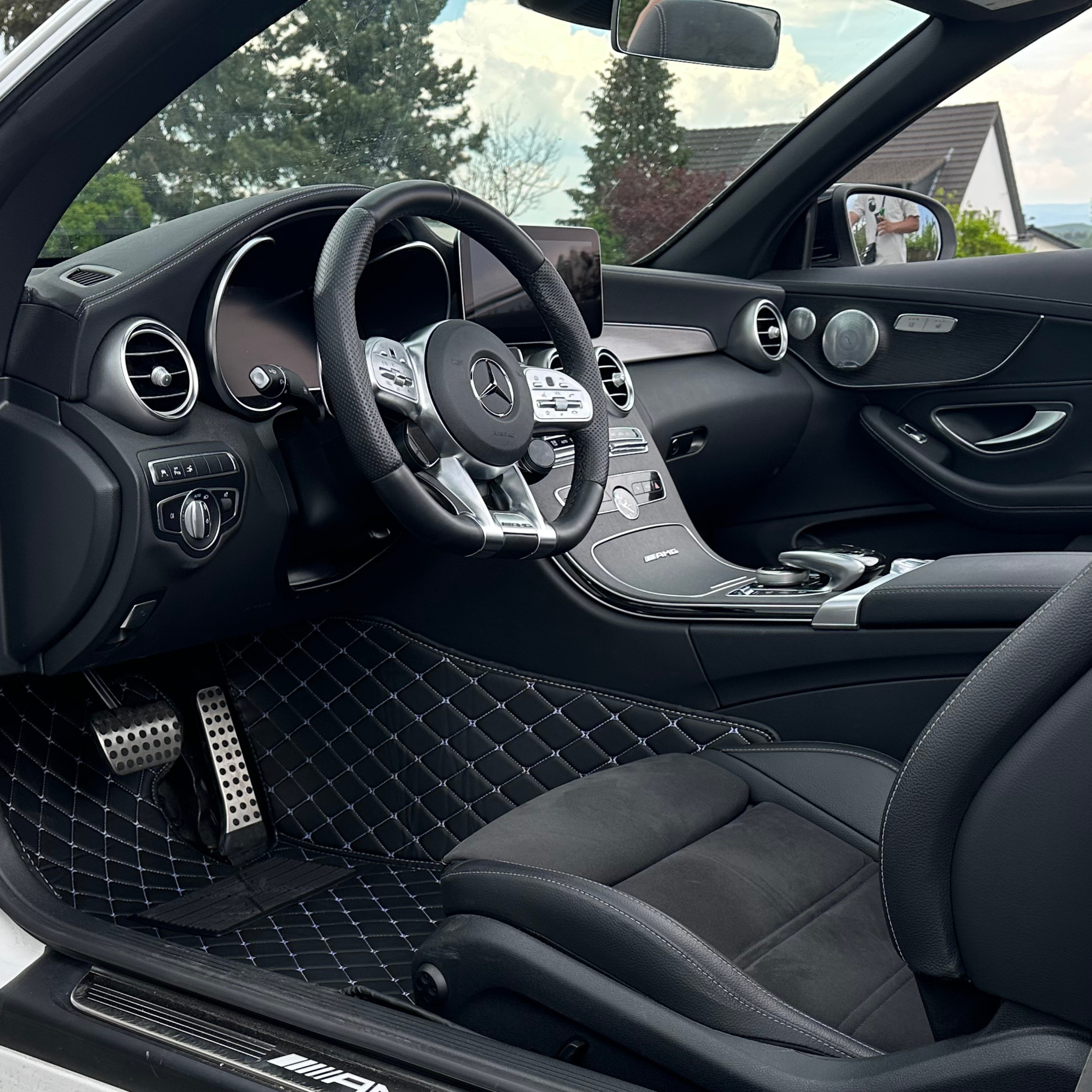 Interior of a luxury car with leather seats and a detailed dashboard.