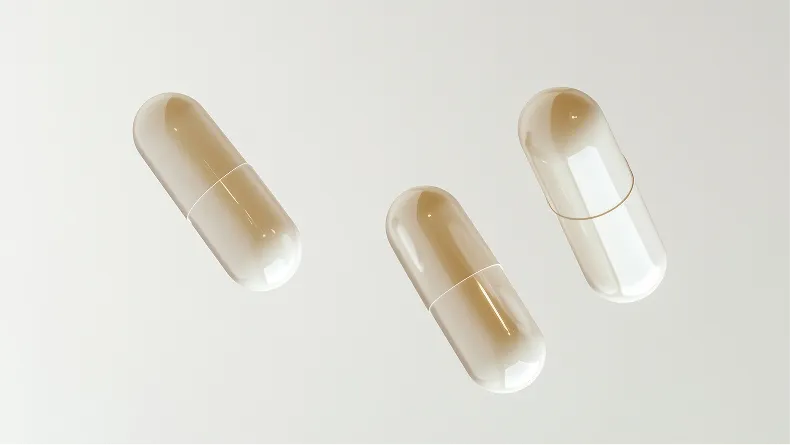 Three translucent, sepia-toned capsules against a plain, off-white background.