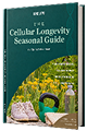 A book with a green cover titled 'Cellular Longevity Seasonal Guide'.