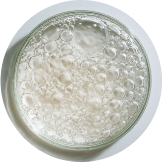 A glass dish filled with clear liquid and bubbles.