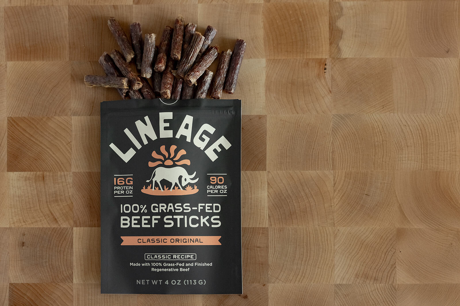 Package of beef sticks on a wooden surface.
