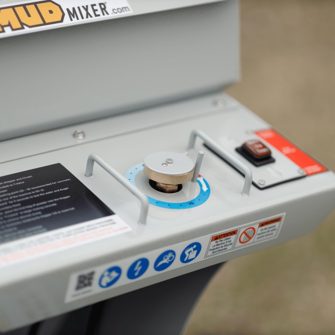 Close-up of a dial and controls on a gray machine panel.