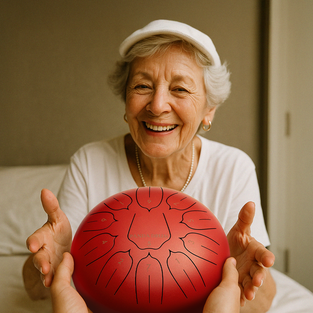 Smiling elderly woman holding a red steel tongue drum.