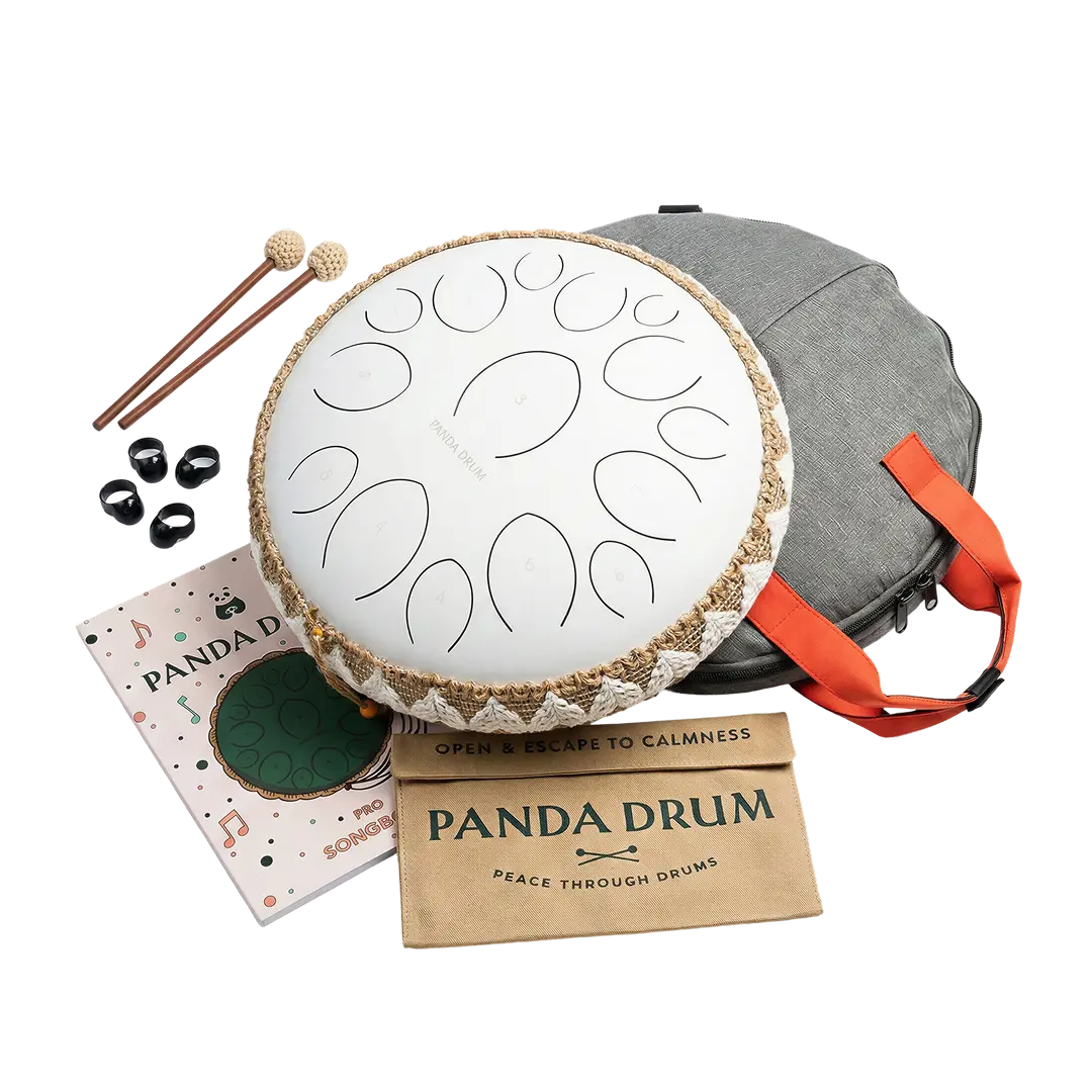 A white Panda Drum steel tongue drum with mallets, a songbook, and a grey carrying case.