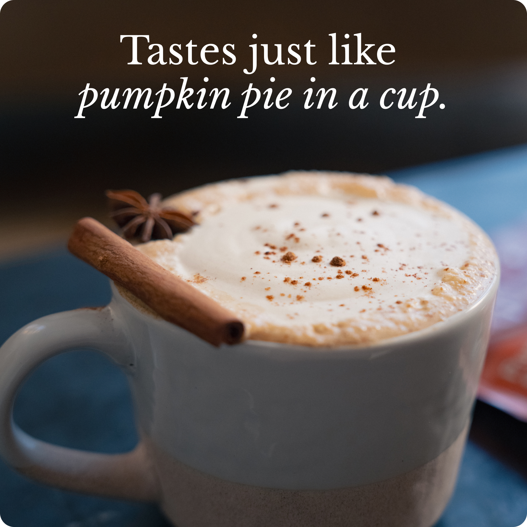 A frothy drink in a mug, garnished with a cinnamon stick and star anise, with overlaid text.