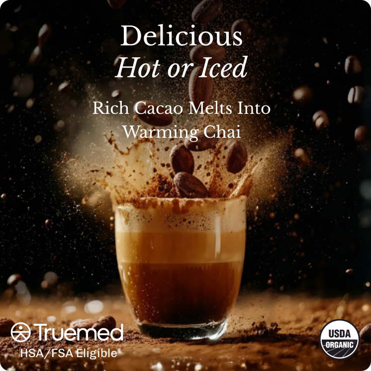A glass of a layered beverage with cacao beans and powder splashing out against a dark background.