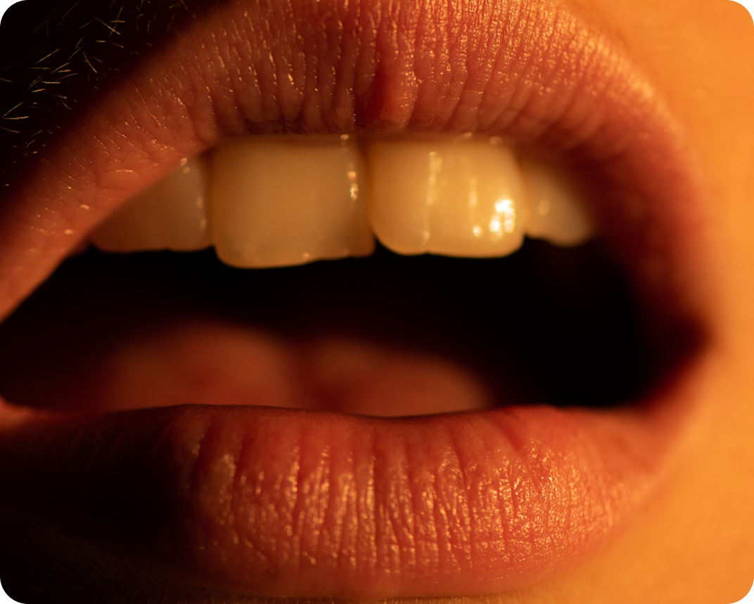 Close-up of an open mouth showing teeth and lips.