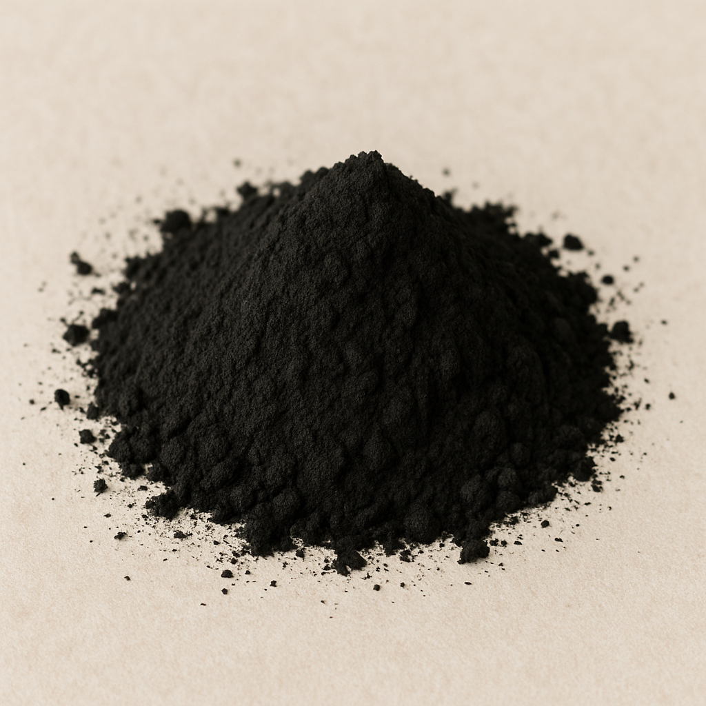 A pile of black powder on a light surface.