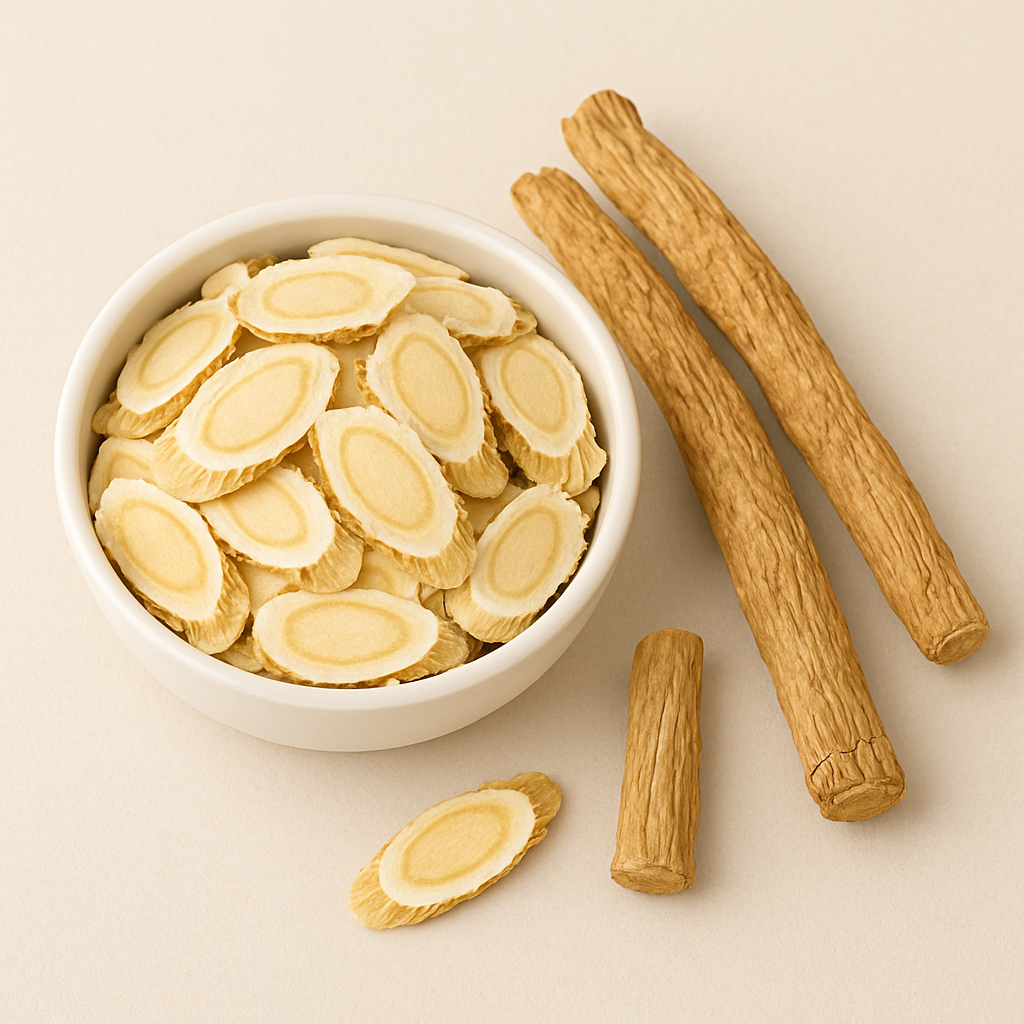 Bowl of sliced dried roots next to whole dried roots on a beige background.