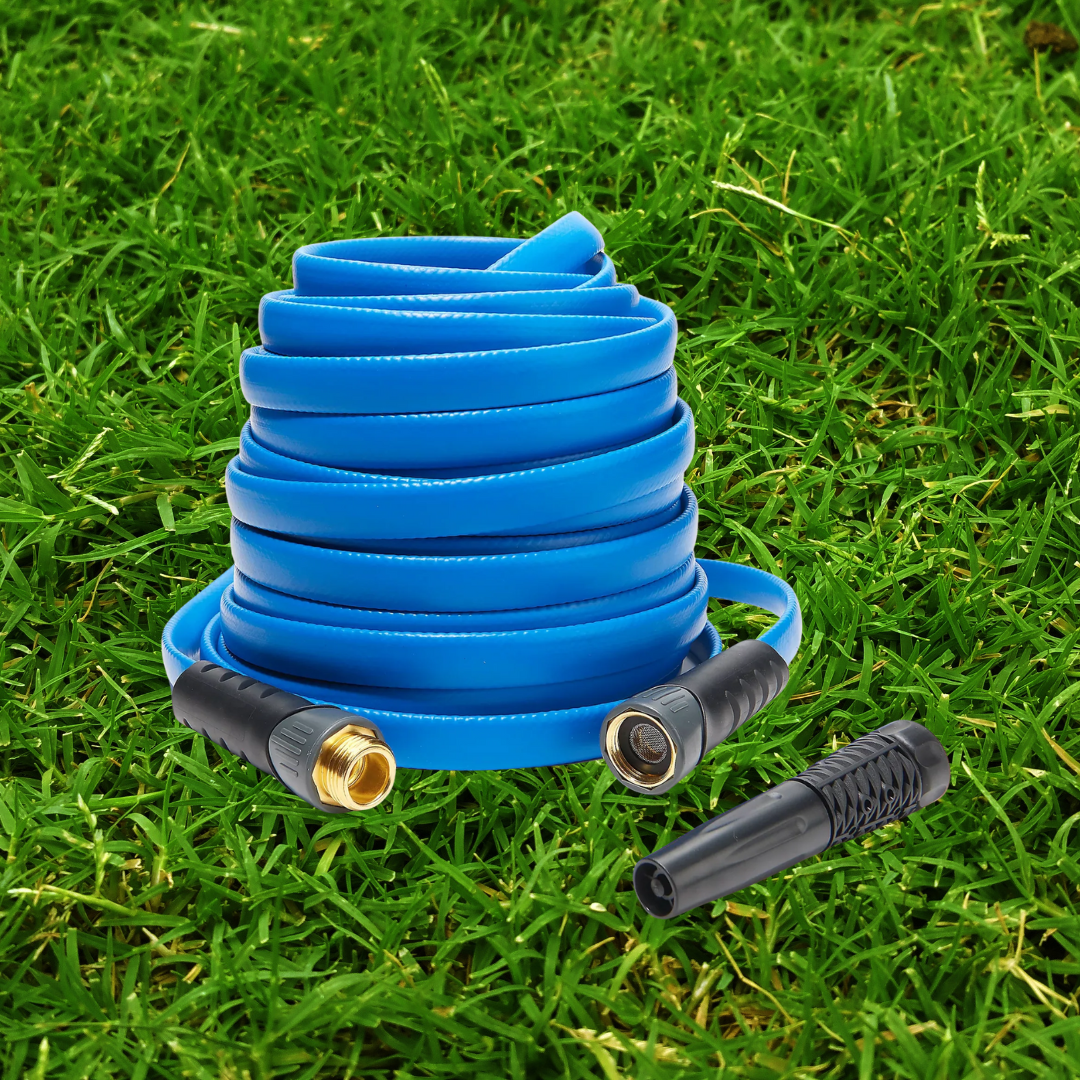 Coiled blue garden hose with connectors on green grass.