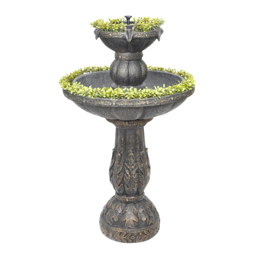 Two-tiered decorative fountain with green foliage accents.