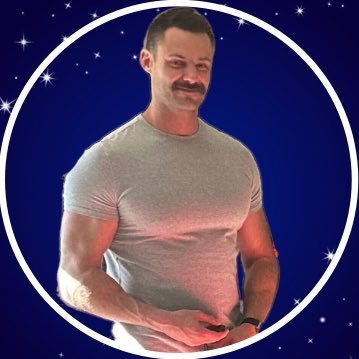Man in a gray shirt with a mustache against a starry blue background.
