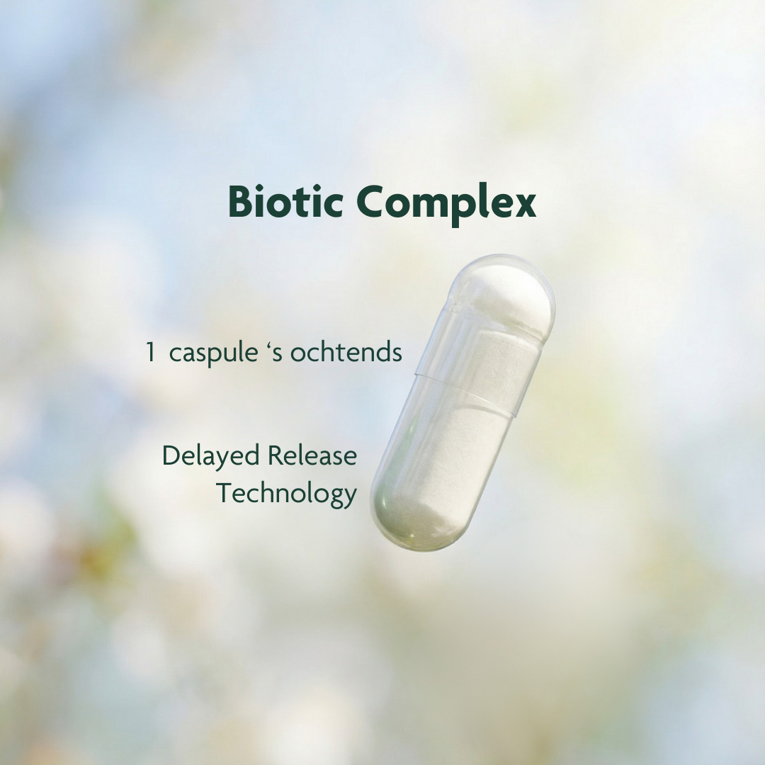 A close-up of a single 'Biotic Complex' capsule against a soft-focus, natural background.
