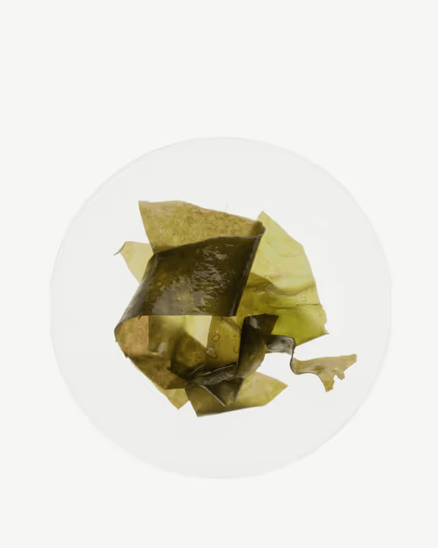 Pieces of seaweed on a white plate.