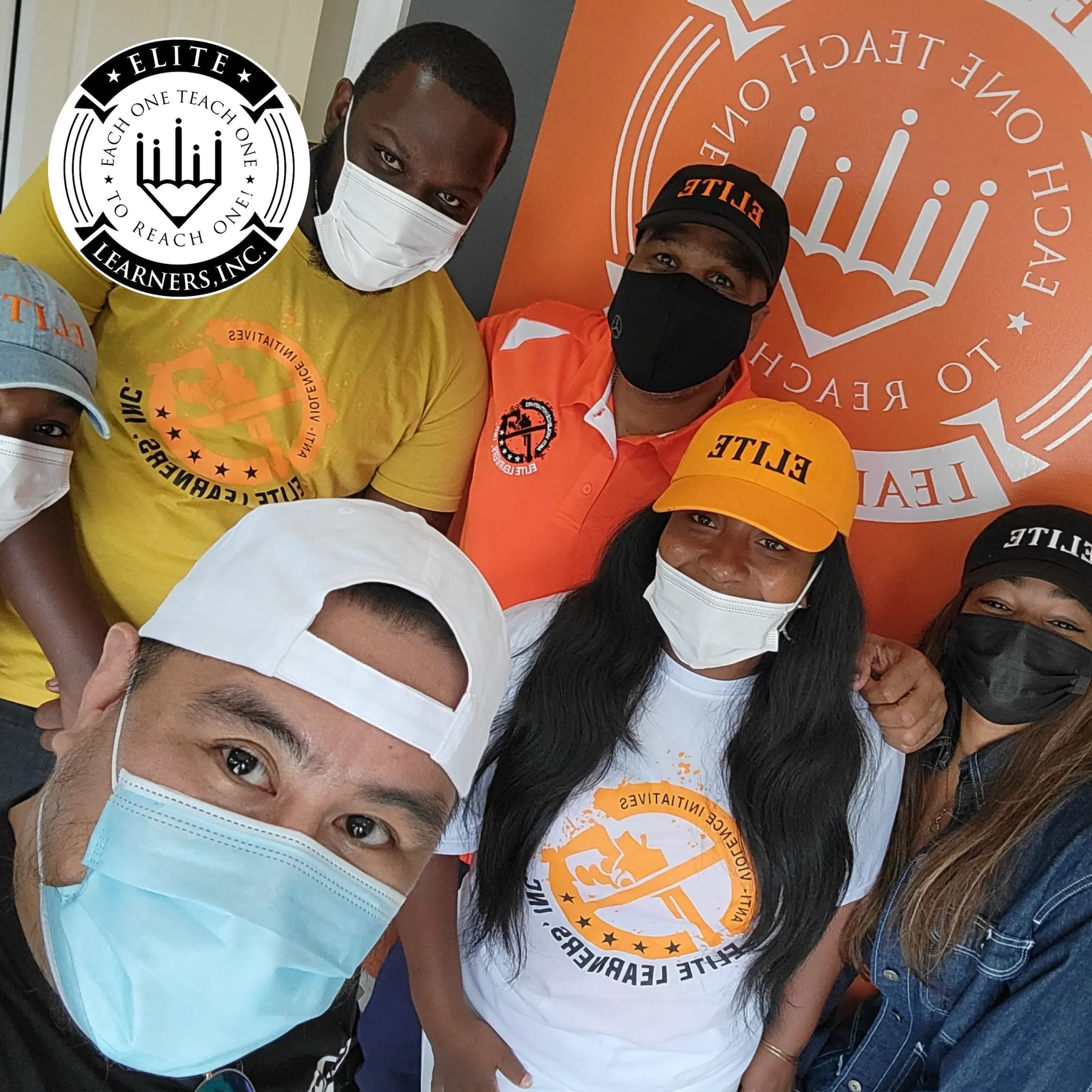 Volunteers from Elite Learners, Inc. wearing branded shirts and masks — empowering youth through mentorship and education.