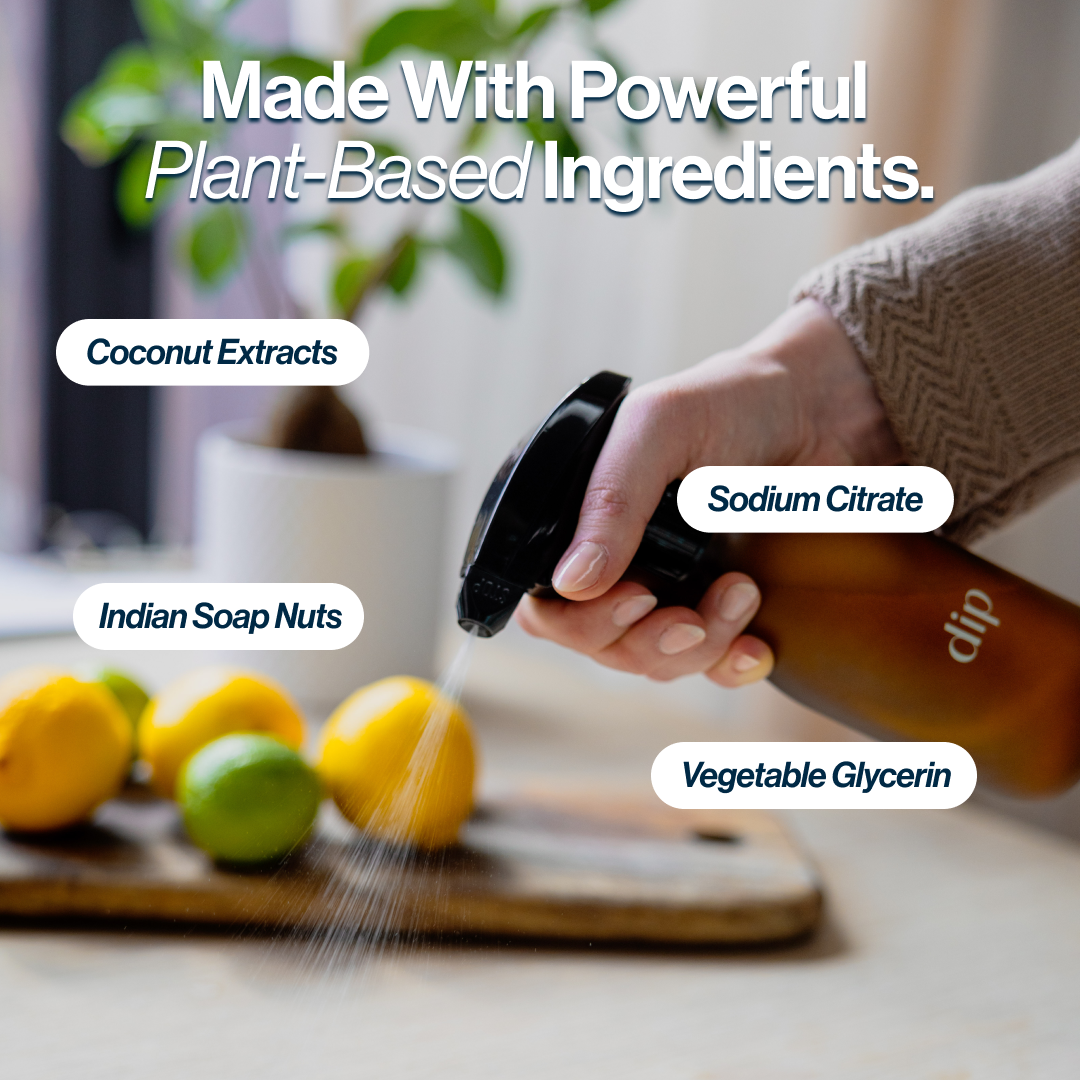 Hand spraying liquid on lemons with text about plant-based ingredients.